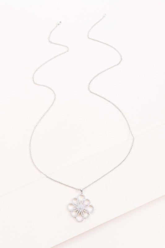 32" floral outline pendant necklace in silver with a flower outline at the bottom encrusted with pave zircon stones.