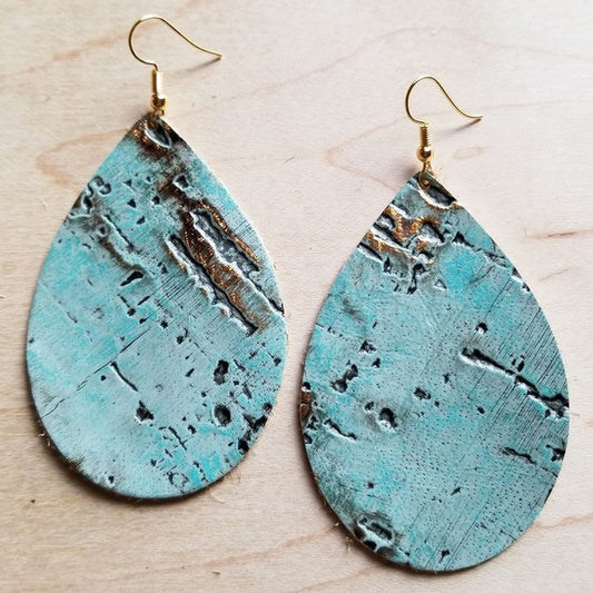 Teardrop shaped genuine leather earrings with hooks with a turquoise metallic finish shown on a wood table.