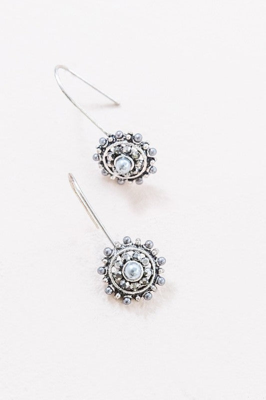 Grey pearl and stone drop earrings in a floral shape with hooks.