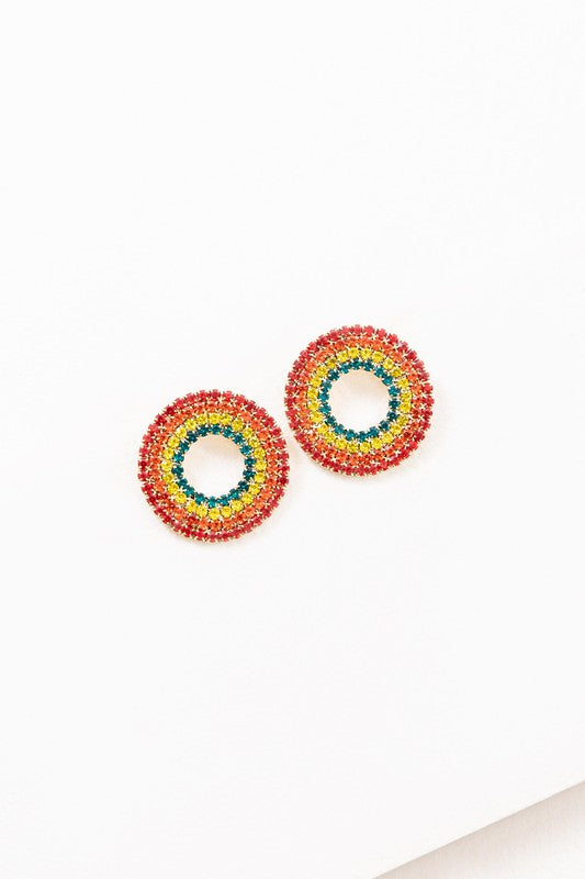 Colorful rainbow earrings with four circular rows of zircon in red, orange, yellow. and green against a white background.