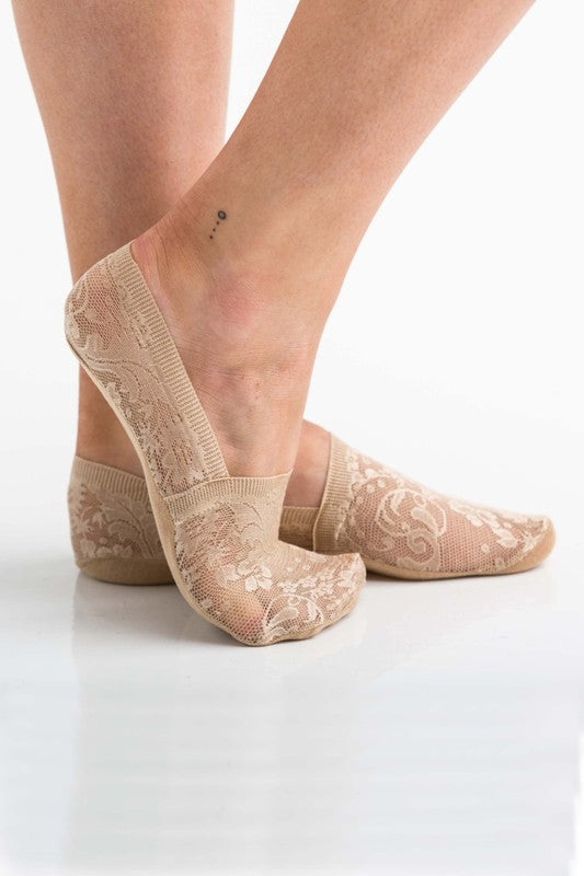 Model wearing tan no slip floral lace socks to wear alone or inside a shoe.