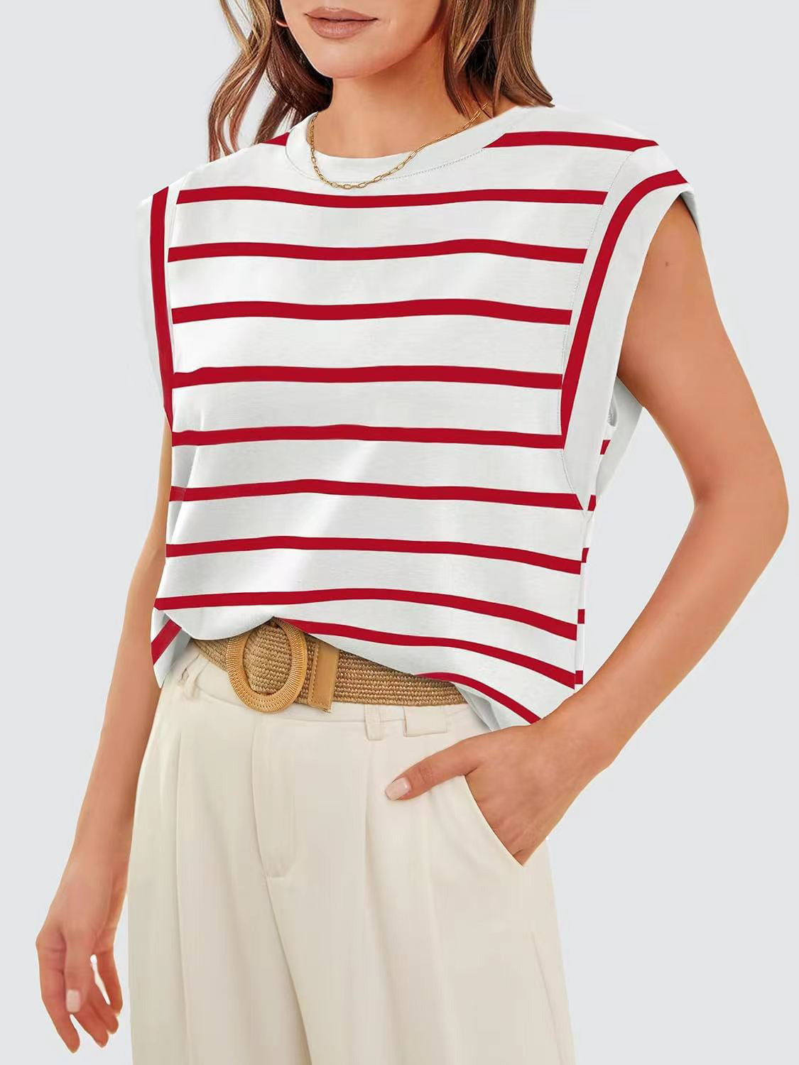 Brunette model wearing winter white pants with a tan belt, featuring the nautical striped, round neck cap sleeve t-shirt in red and white stripes. Several other colors available.