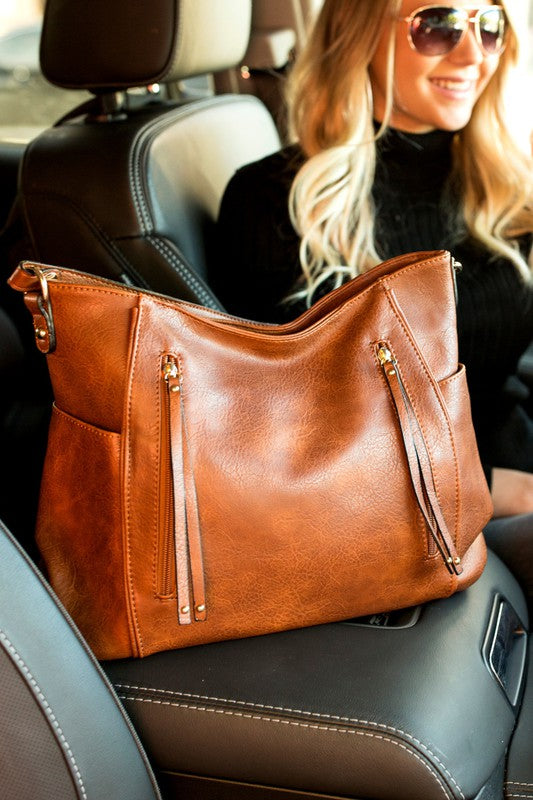Cognac vegan leather tote with tassel details, available in 5 colors.