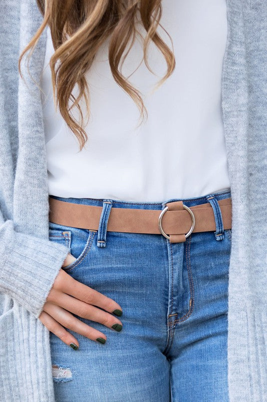 Model wearing tan O-ring belt with distressed denim.