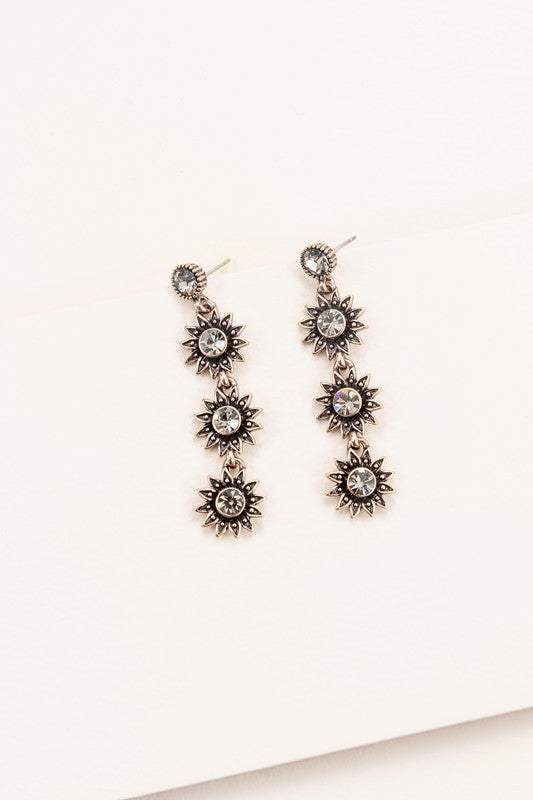 Sunflower drop earrings set in antiqued gold with a top stud and three sunflowers dangling with clear crystals.