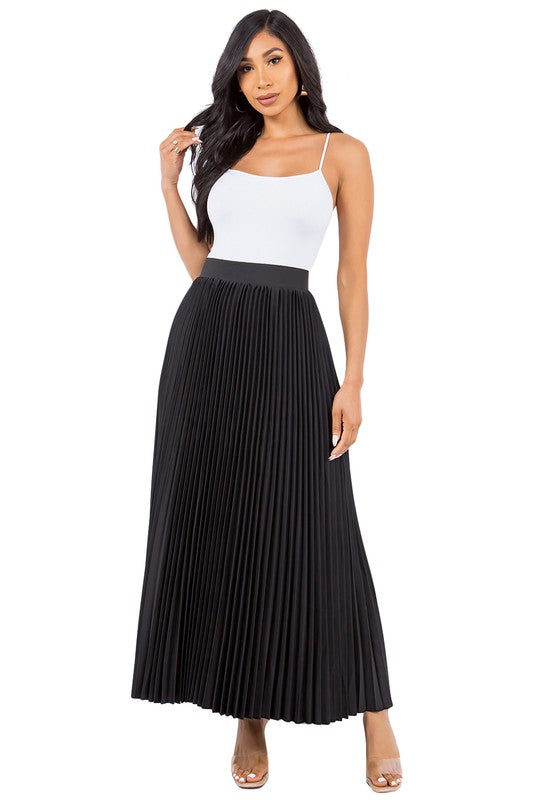 Black pleated maxi skirt on a model with long dark hair wearing a cami top.