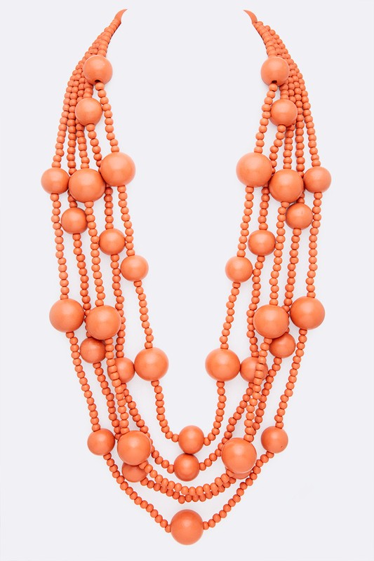 Multi-layered wooden bead necklace in orange against a white background.