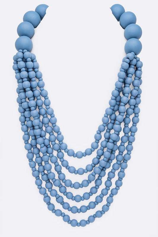 Multistrand wooden bead necklace in light blue. 22 inches plus extender. 