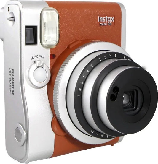 Brown and silver FujiFilm Instax mini 90 camera that's compact and portable for travel.