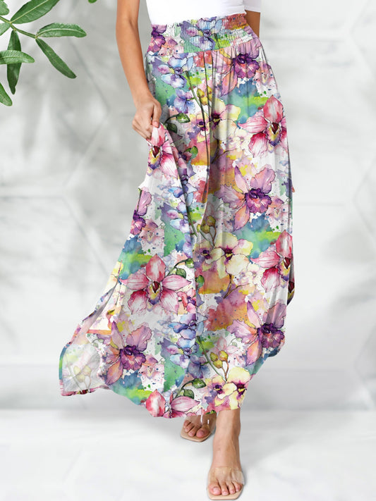 Model wearing a smocked waist, watercolor floral print maxi skirt against a white backdrop.