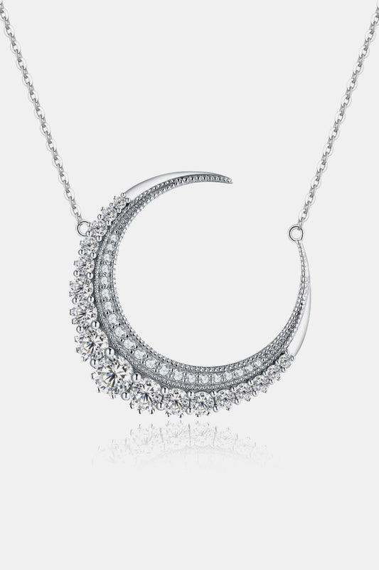 1.8 carat moissanite crescent moon shape necklace in sterling silver with a platinum plating for endurance on a white backdrop.