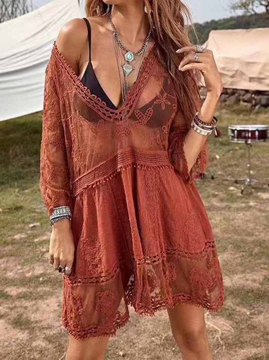 Model wearing a boho style lace cover-up dress in rust with long sleeves and above knee length.