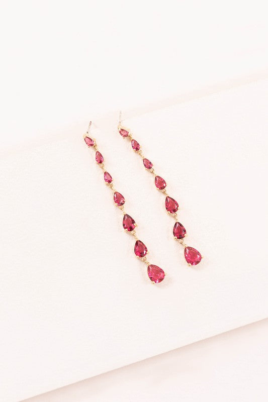 Earrings with a series of pink escalating deep pink crystal droplets set in gold. Clear stones set in silver also available.
