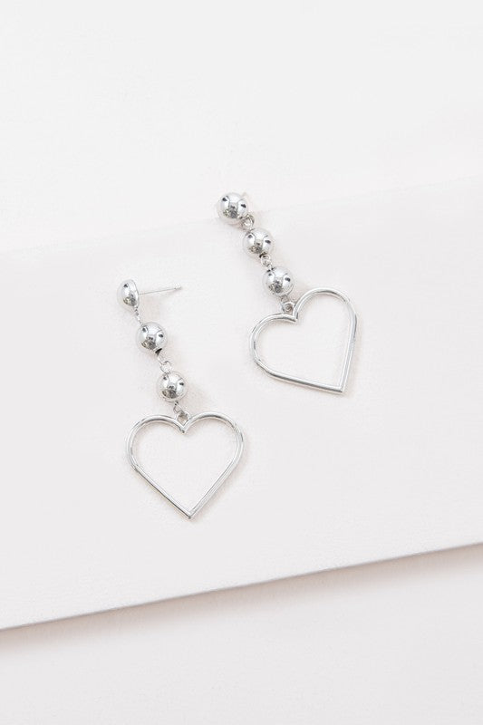 Three bead dangle earrings with a heart outline at the bottom in sterling silver plated brass.