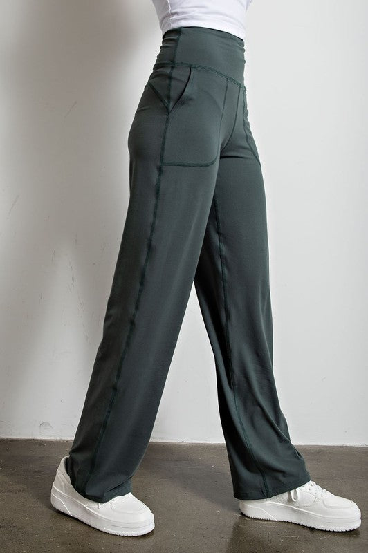 Butter soft straight leg pants in spruce green against a white background.