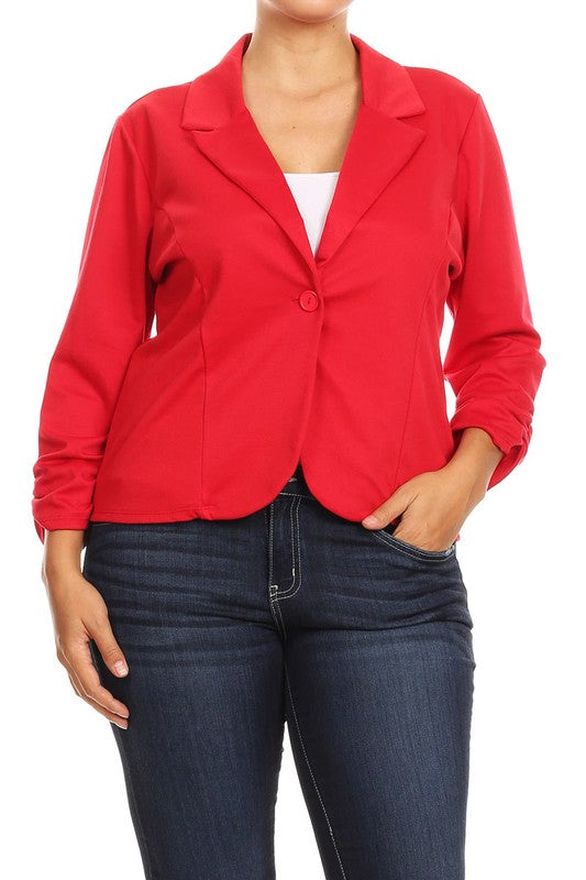 Model wearing a Moa Collection plus size waist length blazer with ruched sleeves in red. Worn with jeans and a white top.
