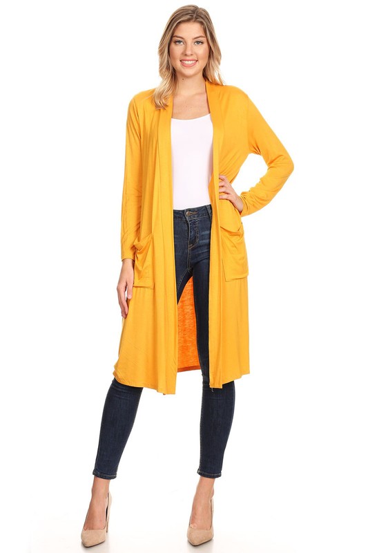 Blonde model wearing a white top and dark jeans with a Moa Collection duster length open cardigan with front pockets in yellow against a white backdrop