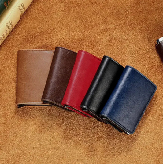 Anti-Theft, RFID and NFC protected vegan leather wallets in camel, brown, red, black, and navy against a tan leather cloth. 