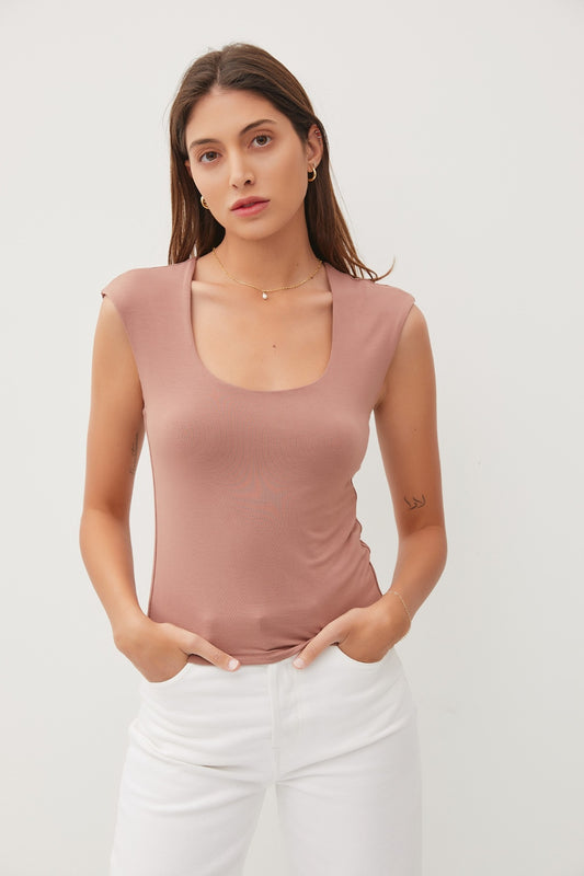 Brunette model wearing a cap sleeve tank with a squared scoop neck in mocha with white jeans.