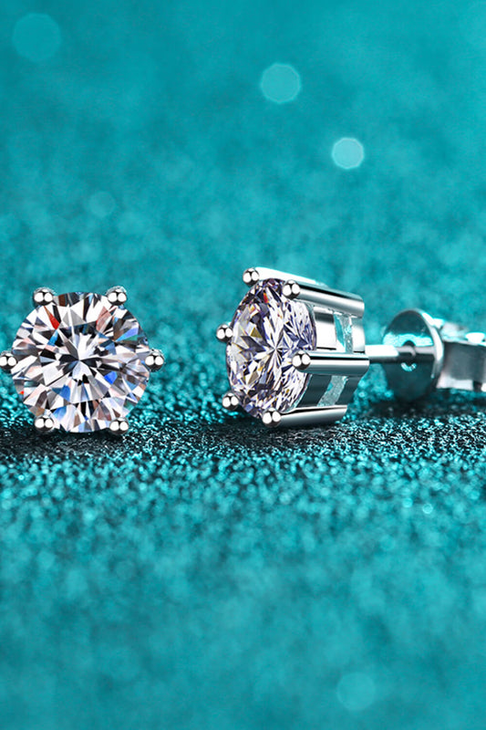 (2) one-half carat Moissanite stud earrings, round on a teal background.