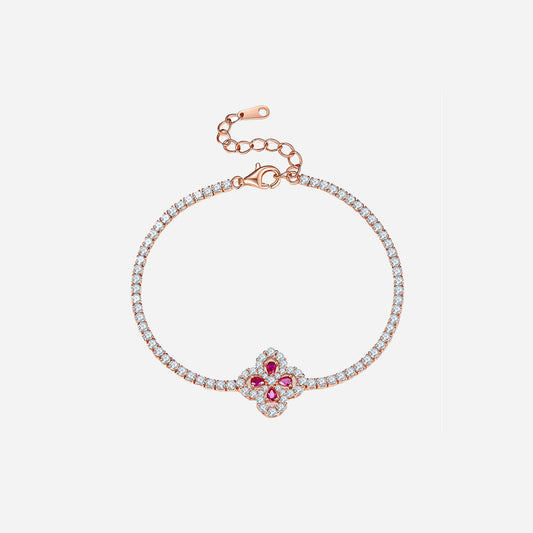 Rose gold plated sterling silver lab grown ruby flower bracelet with zircon accents on a white background.