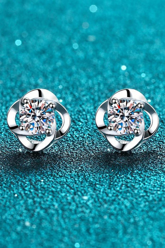 Round Moissanite Stud earrings set in Sterling silver on a teal backgroud