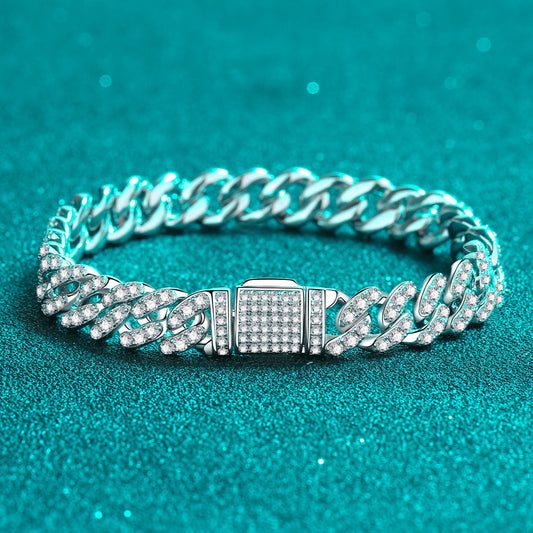 Stunning 1920's sterling silver bracelet with 4.63 carats of Moissanite in small stones inlaid on a thick chain link with a square clasp on a teal background