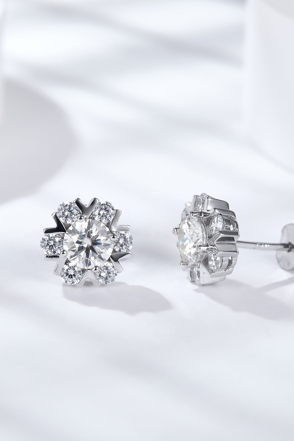 2 carat Moissanite flower stud earrings against a white backdrop.