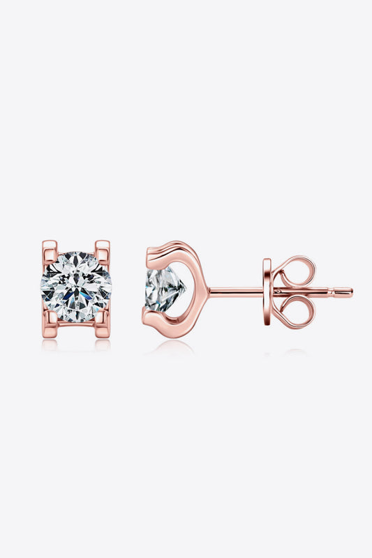 Rose gold plated sterling silver stud earrings with a Moissanite stone in each surrounded by 2 prongs on the top and 2 prongs on the bottom on a white background