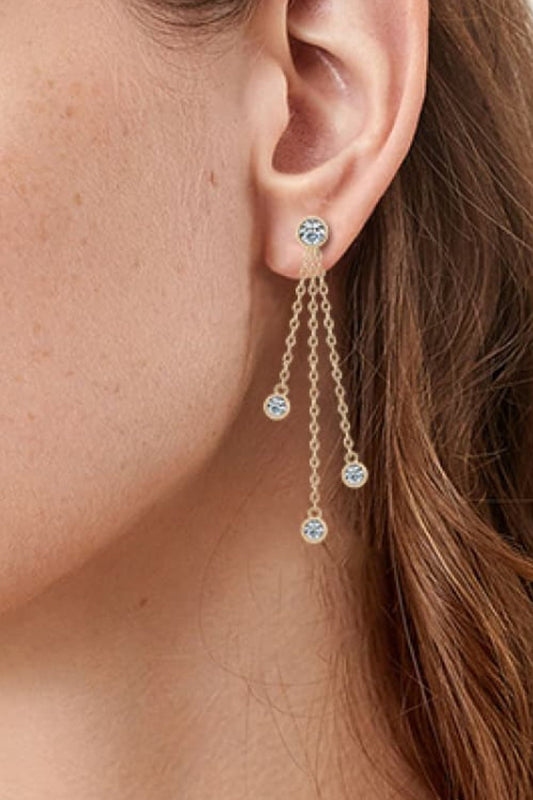 Woman with long red hair wearing gold plated three chain moissanite earrings with one stone at the top and three at the bottom